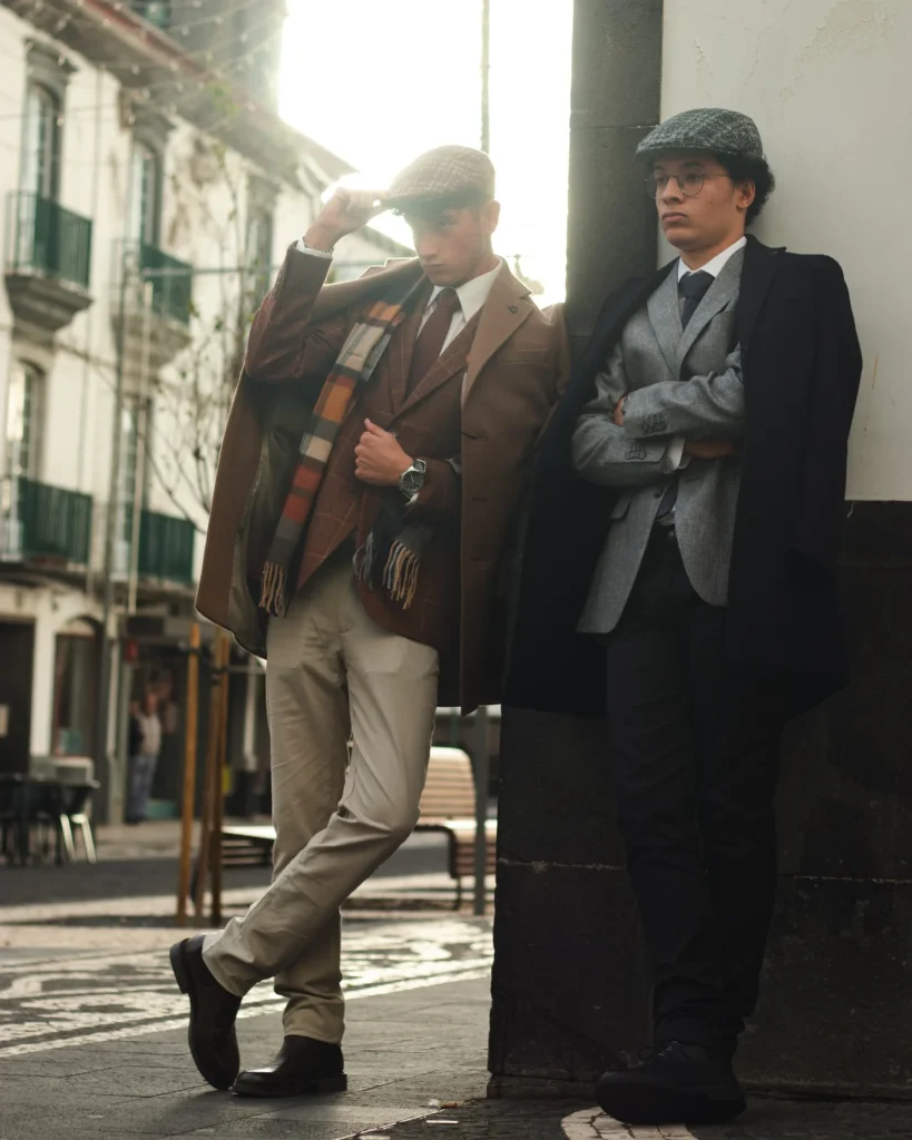 Two models in Londrina suits and overcoats on a street in Ponta Delgada